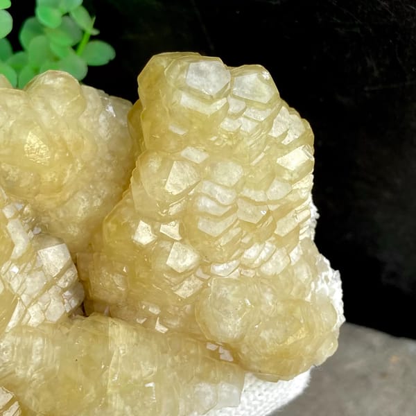 Cluster of honey-yellow stepped calcite columns from Guizhou, China, close-up of the crystal faces