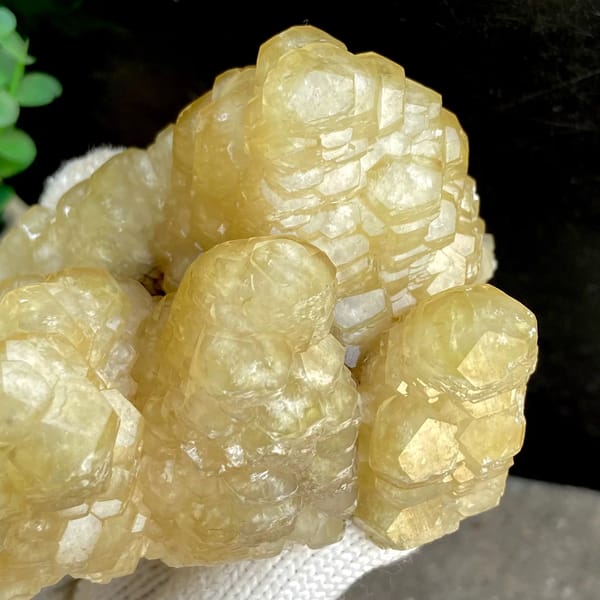 Cluster of honey-yellow stepped calcite columns from Guizhou, China, detail of the matrix contact
