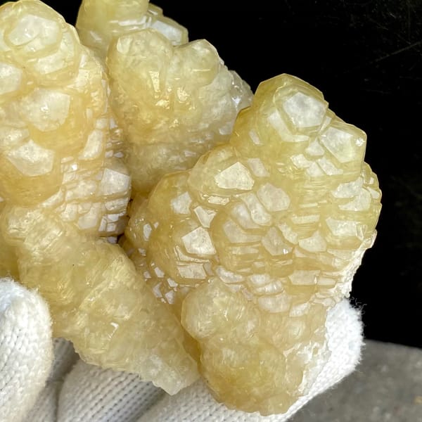 Cluster of honey-yellow stepped calcite columns from Guizhou, China, close-up of terminations