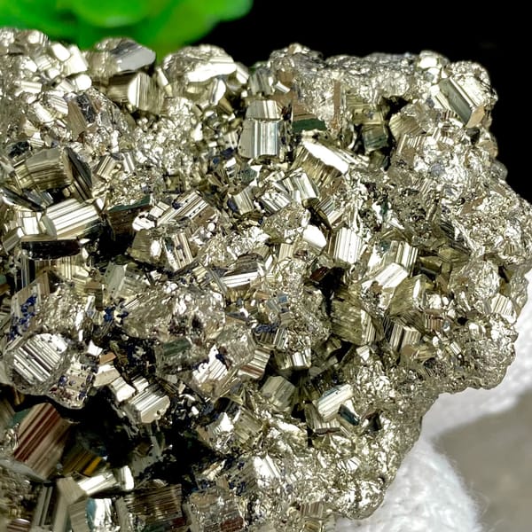 Rounded cluster of bright pyrite dodecahedra from Peru, top view