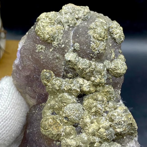 Pale pyrite rosettes over plum-purple fluorite from Jiangxi, China, close-up of terminations