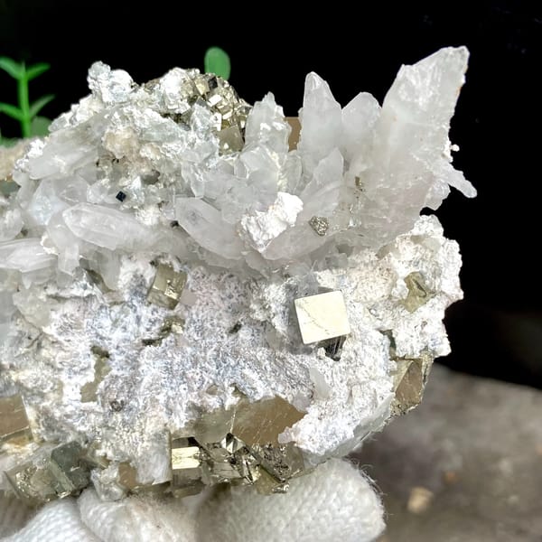 White quartz needles fanning over pyrite-studded base from Shangbao, Hunan, China, close-up of the crystal faces