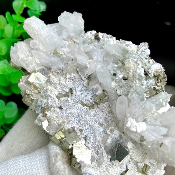 White quartz needles fanning over pyrite-studded base from Shangbao, Hunan, China, detail of the matrix contact