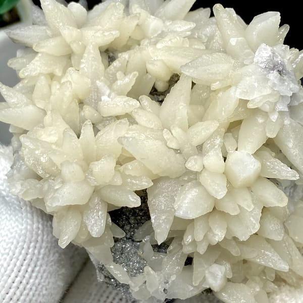 Dome of white flower-form calcite points from Guizhou, China, close-up of the crystal faces