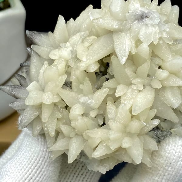 Dome of white flower-form calcite points from Guizhou, China, detail of the matrix contact