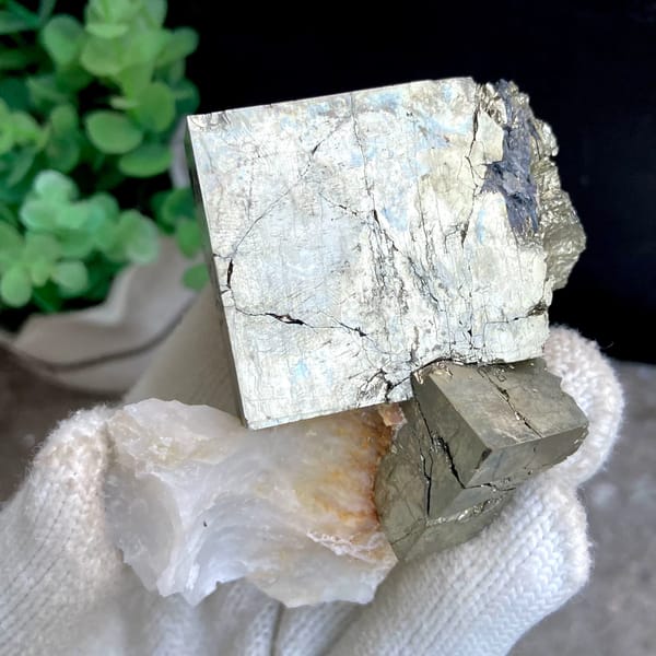 Large pale pyrite cube on pyrite base with white quartz from Shangbao, Hunan, China, close-up of the crystal faces