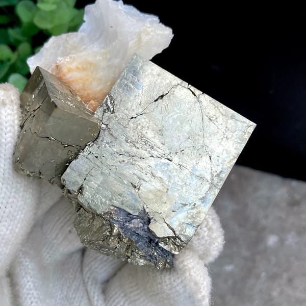 Large pale pyrite cube on pyrite base with white quartz from Shangbao, Hunan, China, detail of the matrix contact