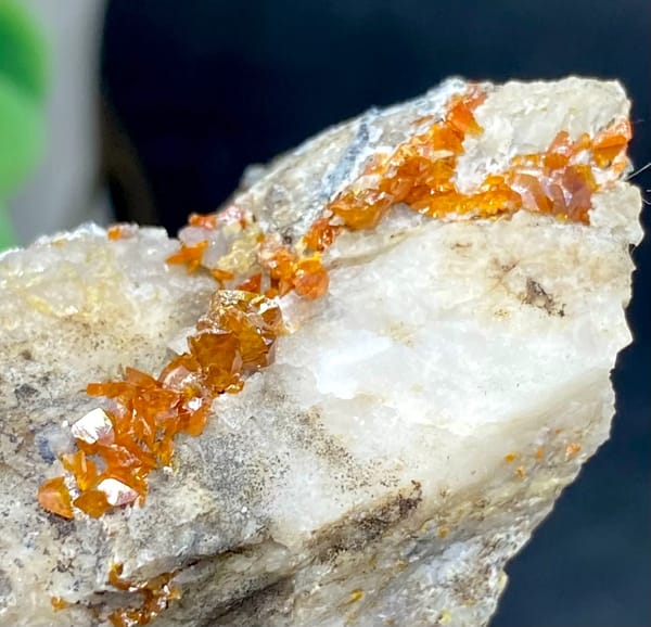 Tall white matrix wedge with orange-red wulfenite from Sichuan, China, close-up of the crystal faces