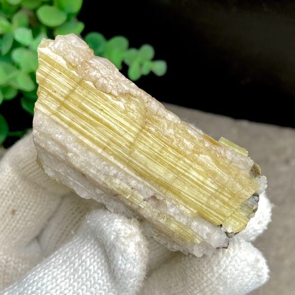 Tall golden topaz column with white matrix from Germany, close-up of the crystal faces