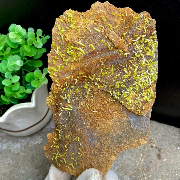 Plate of rusty matrix sprinkled with green pyromorphite needles from Wuzhou, Guangxi, China, detail of the matrix contact