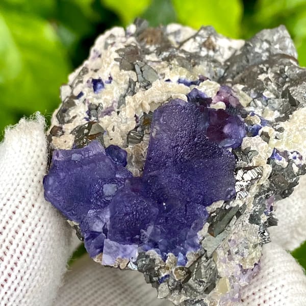 Vivid purple fluorite octahedron on grey arsenopyrite from Inner Mongolia, China, reverse side