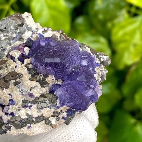 Vivid purple fluorite octahedron on grey arsenopyrite from Inner Mongolia, China, close-up of terminations