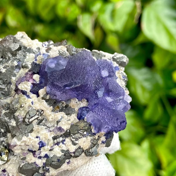 Vivid purple fluorite octahedron on grey arsenopyrite from Inner Mongolia, China, overall view