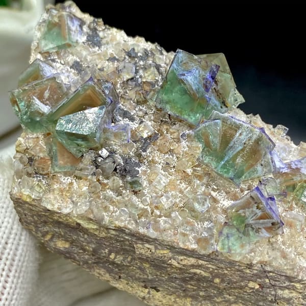 Green fluorite cubes with purple edges on grey matrix from Hebei, China, reverse side
