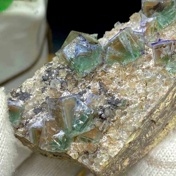 Green fluorite cubes with purple edges on grey matrix from Hebei, China, side view