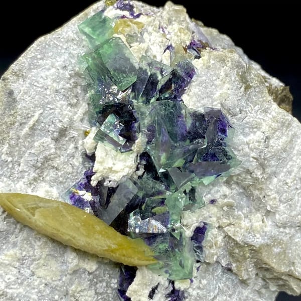 Purple-cored green fluorite cubes with yellow siderite blade from Inner Mongolia, China, side view