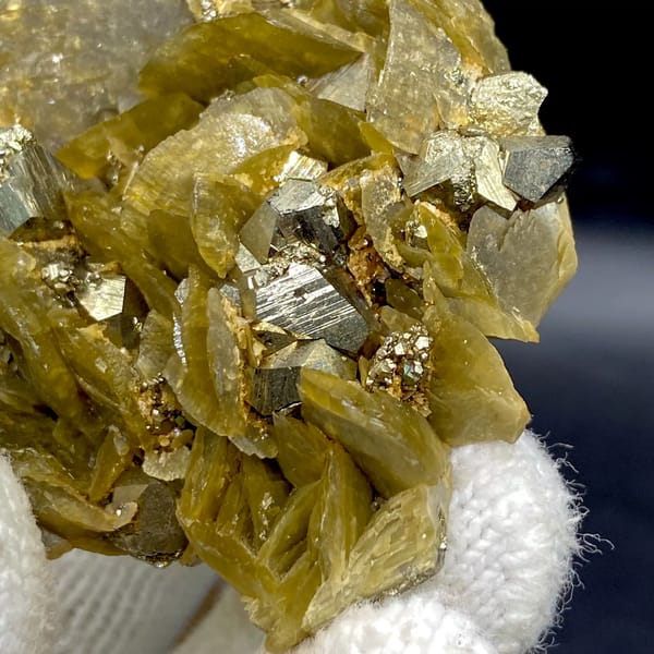 Olive siderite blades studded with bright pyrite dodecahedra from Guizhou, China, top view