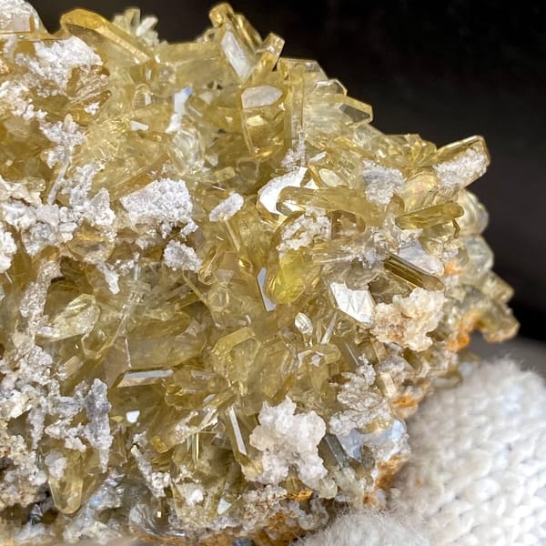 Dense cluster of golden transparent baryte blades from Yunnan, China, side view
