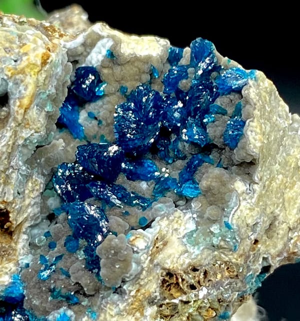 Deep blue veszelyite crystals in pale pocket from Yunnan, China, close-up of the crystal faces