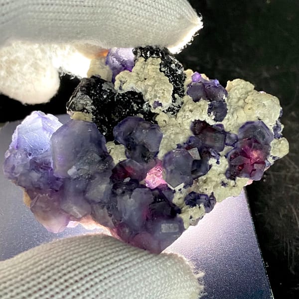 Frosted lavender phantom fluorite with black crystals and cream druse from Inner Mongolia, China, second angle