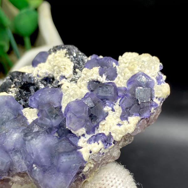 Frosted lavender phantom fluorite with black crystals and cream druse from Inner Mongolia, close-up of the crystal faces