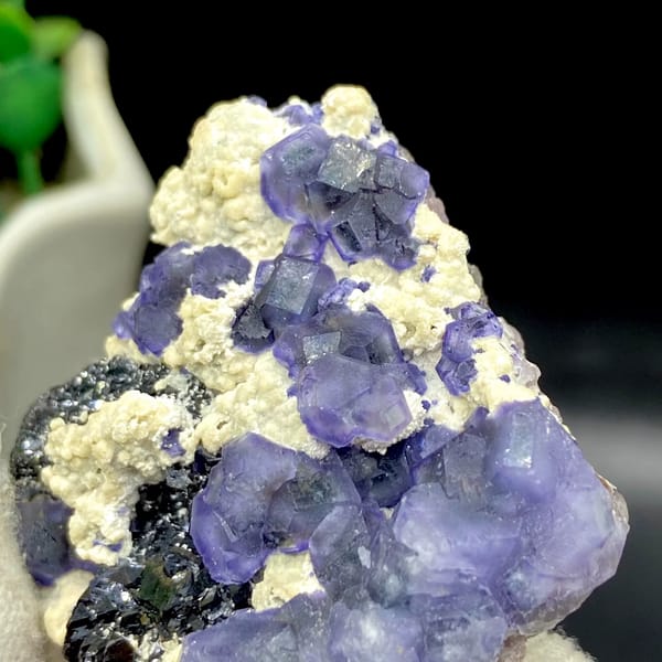 Frosted lavender phantom fluorite with black crystals and cream druse from Inner Mongolia, China, side view