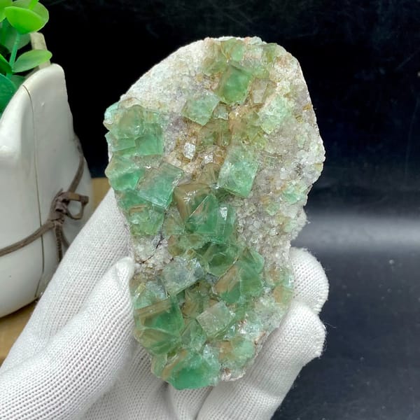 Glassy sea-green fluorite cubes on pale matrix plate from Hebei, China, detail of the matrix contact