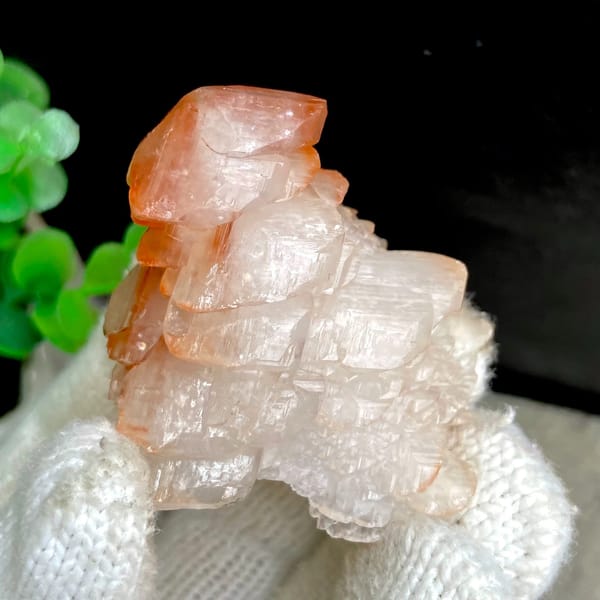 Pagoda-shaped calcite with red-capped top from Hubei, China, close-up of the crystal faces
