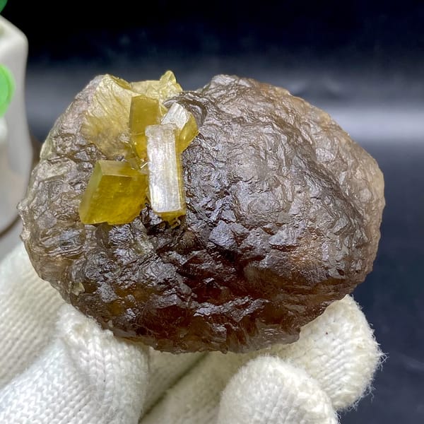 Golden baryte blades on smooth brown fluorite ball from Jiangxi, China, close-up of the crystal faces