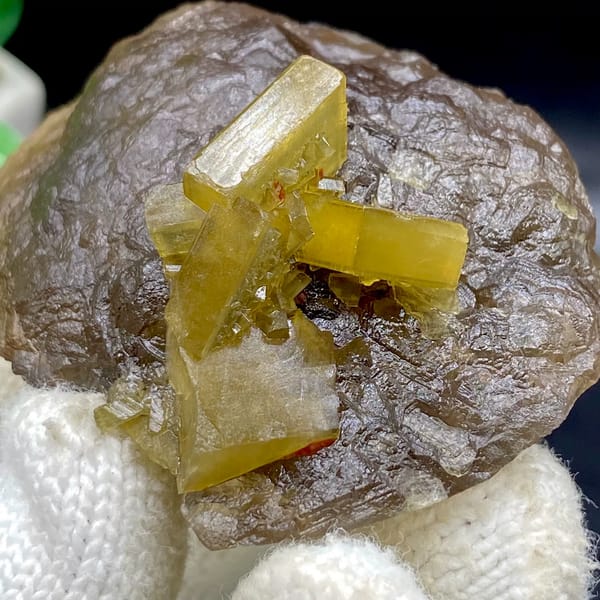 Golden baryte blades on smooth brown fluorite ball from Jiangxi, China, detail of the matrix contact
