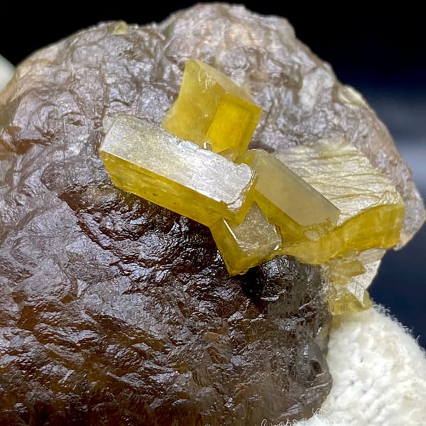 Golden baryte blades on smooth brown fluorite ball from Jiangxi, China, side view