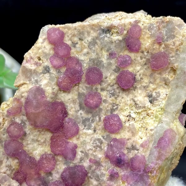 Raspberry strawberry-fluorite balls on tall tan plate from Henan, China, second angle