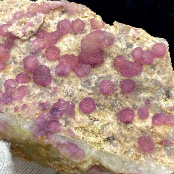 Raspberry strawberry-fluorite balls on tall tan plate from Henan, China, reverse side