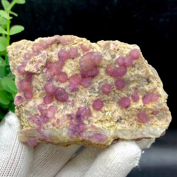 Raspberry strawberry-fluorite balls on tall tan plate from Henan, China, overall view