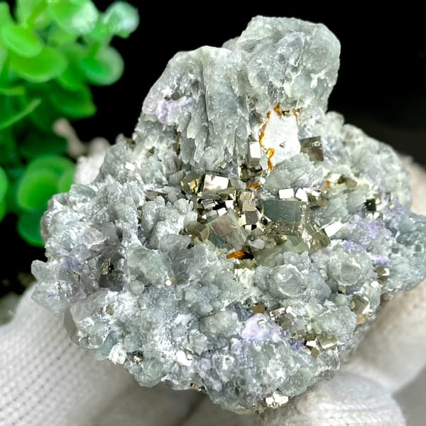 Brassy pyrite cubes on pale green quartz from Shangbao, Hunan, China, detail of the matrix contact