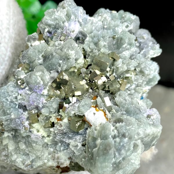 Brassy pyrite cubes on pale green quartz from Shangbao, Hunan, China, side view