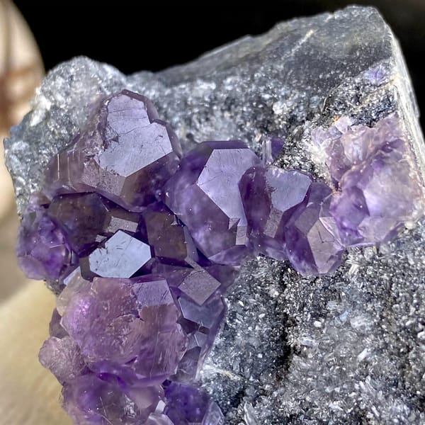 Transparent violet fluorite cubes on dark grey block from Fujian, China, top view