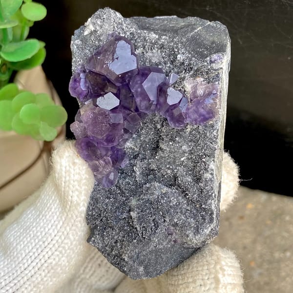 Transparent violet fluorite cubes on dark grey block from Fujian, China, overall view
