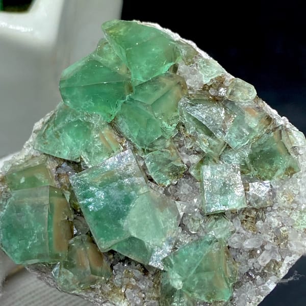Transparent green fluorite cubes on sparkling quartz from Hebei, China, reverse side