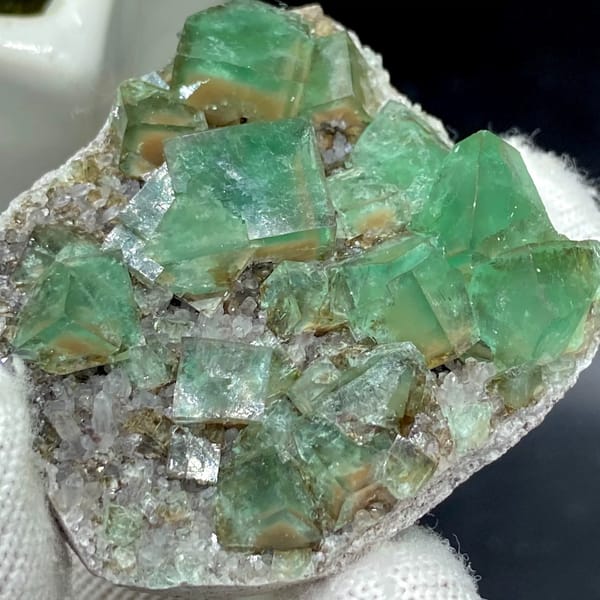 Transparent green fluorite cubes on sparkling quartz from Hebei, China, side view