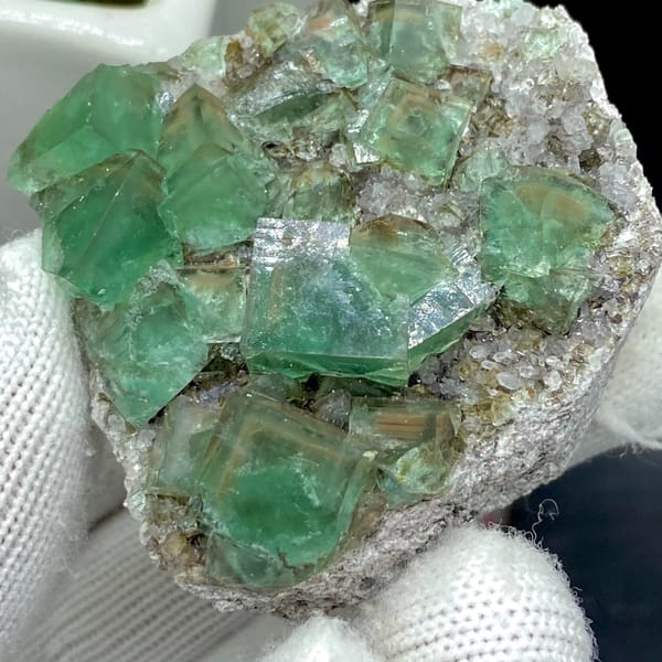 Transparent green fluorite cubes on sparkling quartz from Hebei, China, close-up of terminations