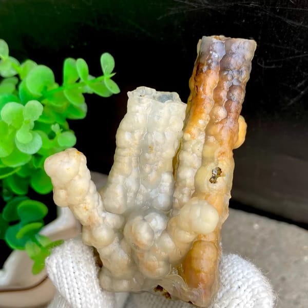 Three tube-shaped agate stalactites in grey and caramel from Indonesia, second angle