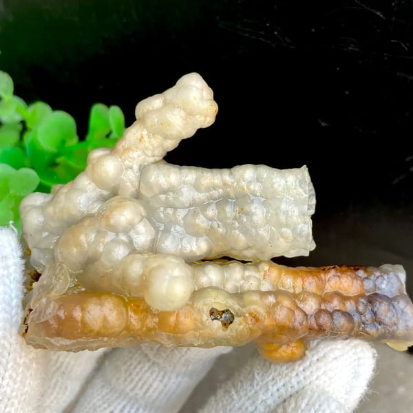 Three tube-shaped agate stalactites in grey and caramel from Indonesia, close-up of the crystal faces