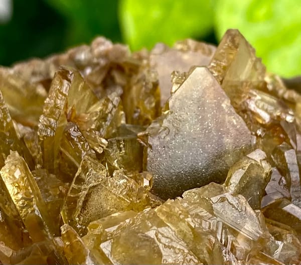 Rounded cluster of amber transparent baryte blades from Yunnan, China, reverse side