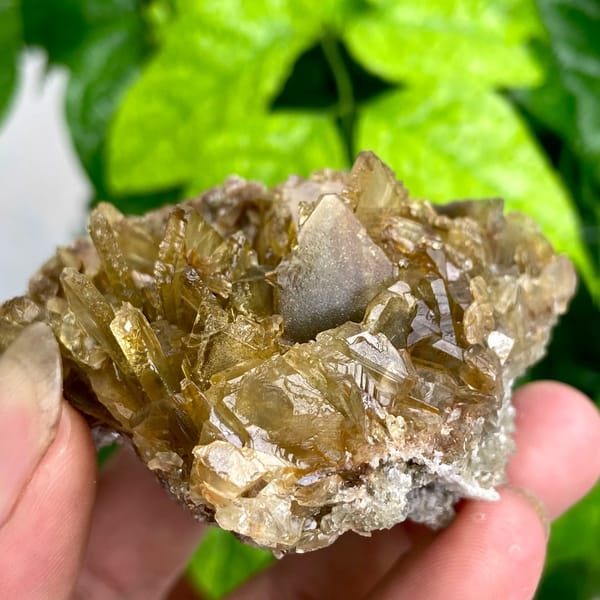 Rounded cluster of amber transparent baryte blades from Yunnan, China, close-up of terminations