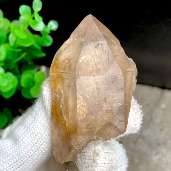 Transparent single quartz crystal with golden phantom from Sichuan, China, close-up of the crystal faces