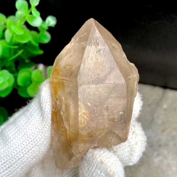 Transparent single quartz crystal with golden phantom from Sichuan, China, detail of the matrix contact