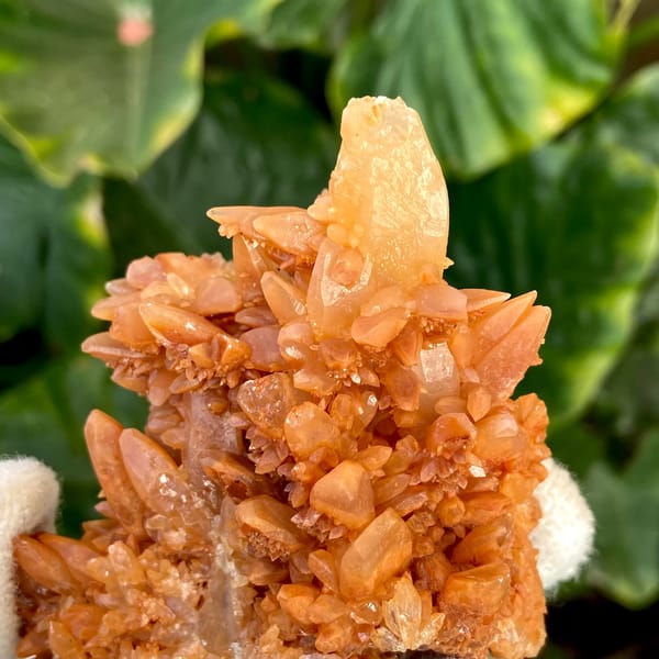 Orange calcite cluster of stacked pointed crystals from Yunnan, China, detail of the matrix contact
