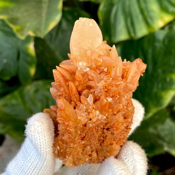 Orange calcite cluster of stacked pointed crystals from Yunnan, China, side view