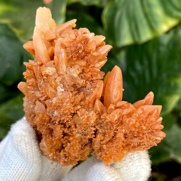 Orange calcite cluster of stacked pointed crystals from Yunnan, China, close-up of terminations